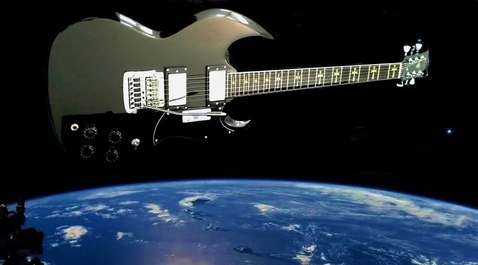 A Galaxy custom electric guitar floating in orbit above the Earth